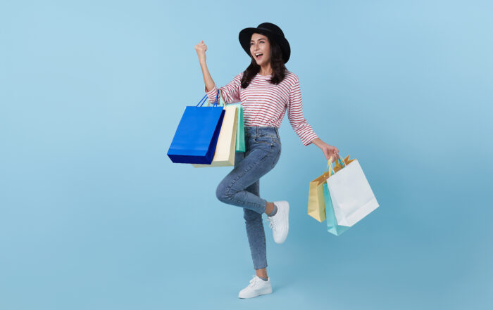 Cheerful happy thai asian woman enjoying shopping, she is carryi  Mitra IT | Your Trusted & Reliable Software Solutions