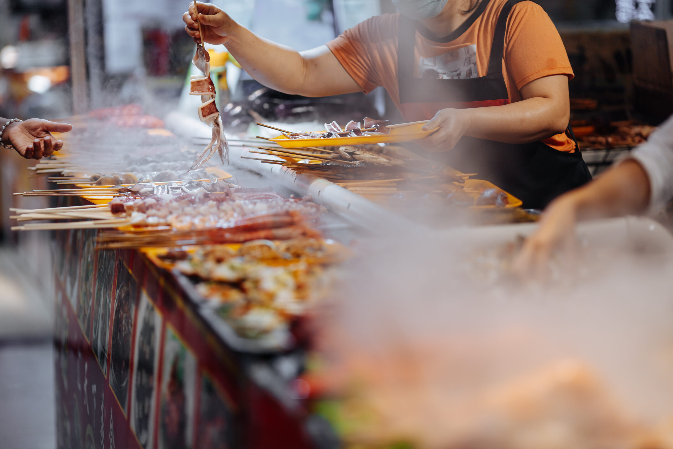 Large variety of delicious grilled seafood on asian market Mitra IT | Your Trusted & Reliable Software Solutions
