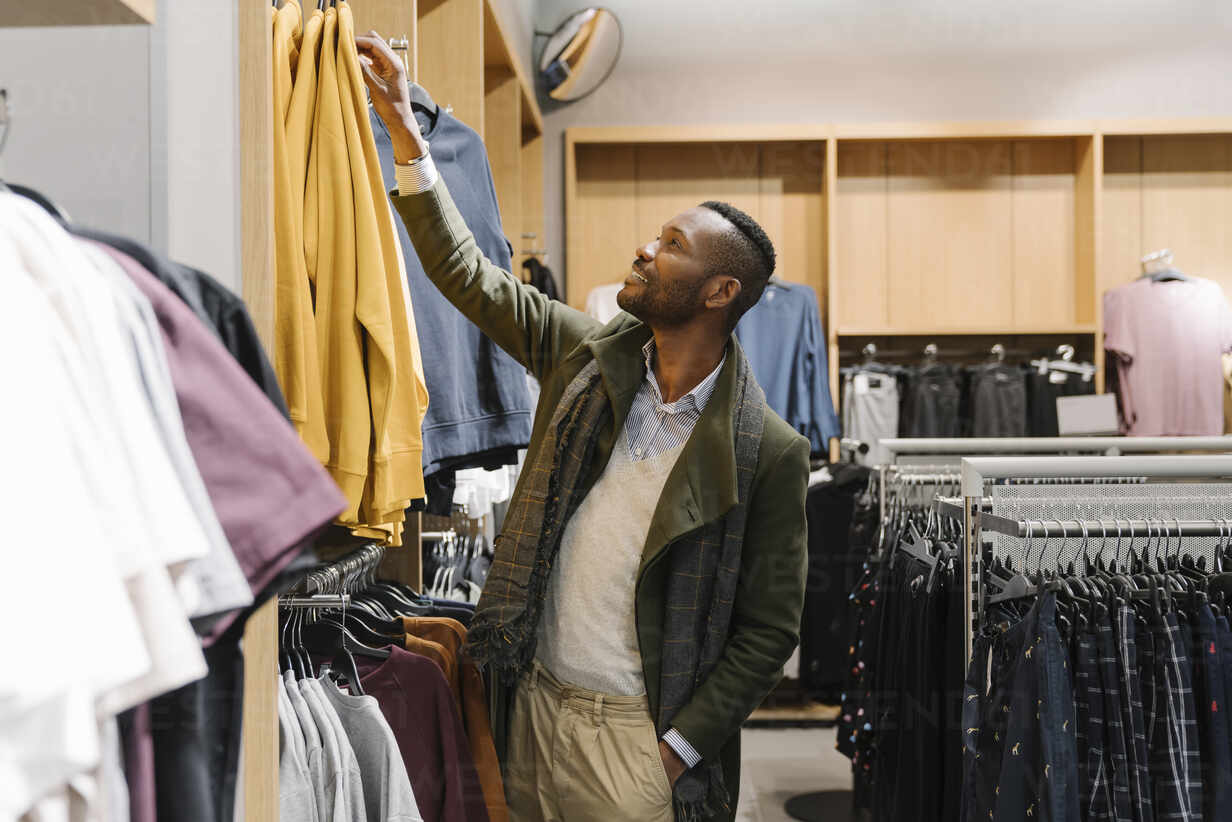 Stylish man shopping in a clothes store The Future of Retail and Wholesale Technology Mitra IT | Your Trusted & Reliable Software Solutions tecnology, retail, wholesale